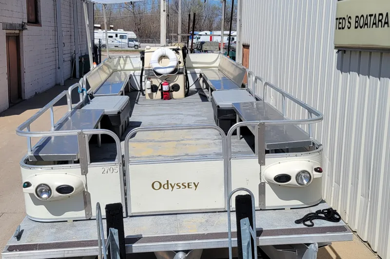 The Image of 2003 Odyssey Millennium pontoon boat on trailer outside Ted's Boatarama. - 0