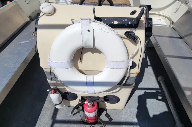 Slide: The Image of 2003 Odyssey Millennium boat console with life preserver and fire extinguisher. - 13
