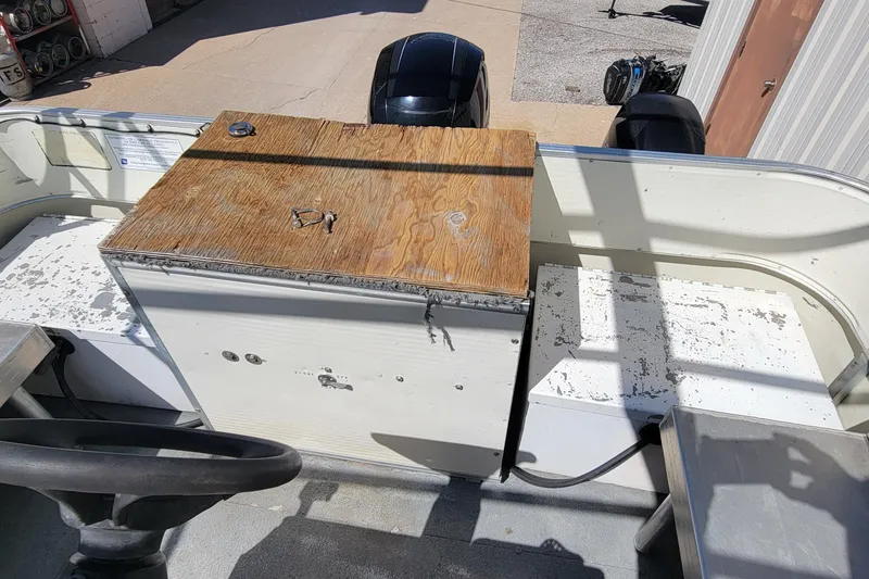 Slide: The Image of 2003 Odyssey Millennium boat interior with worn surfaces and wooden panel. - 14