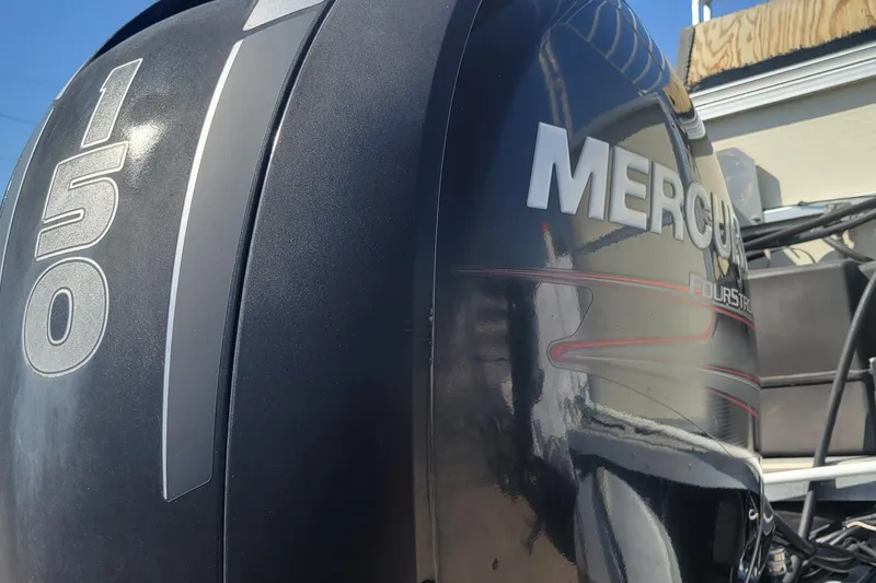 Slide: The Image of Mercury 150 FourStroke outboard motor on a 2003 Odyssey Millennium boat. - 19