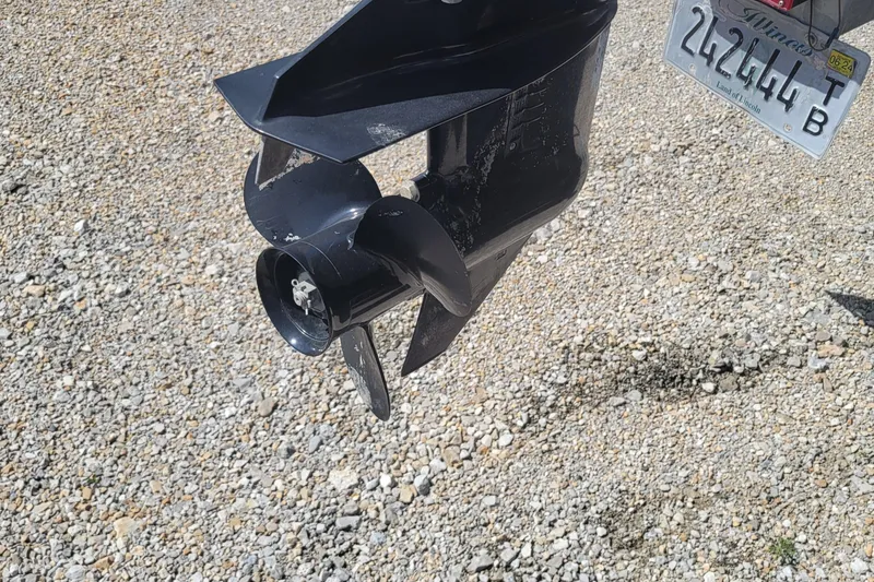 Slide: The Image of Close-up of a 2003 Odyssey Millennium boat propeller and Illinois license plate on gravel. - 22