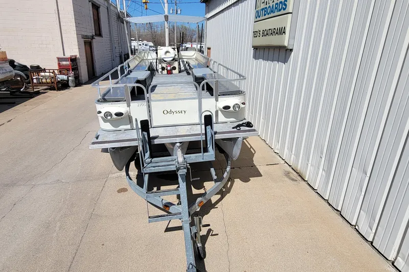 Slide: The Image of 2003 Odyssey Millennium boat on trailer outside a marine shop. - 3