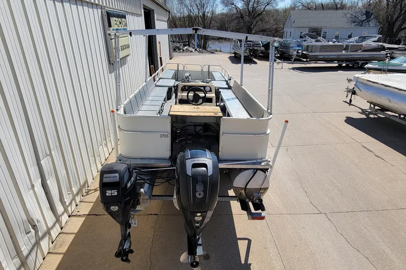 Slide: The Image of 2003 Odyssey Millennium pontoon boat with dual Mercury outboard motors in a marina setting. - 4
