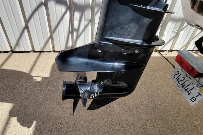 Slide: The Image of Close-up of a 2003 Odyssey Millennium boat motor with visible propeller and license plate. - 6
