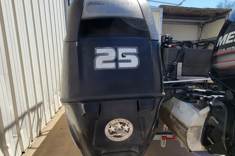 Slide: The Image of 2003 Odyssey Millennium boat engine with Mercury 25 horsepower, ultra-low emission label. - 8