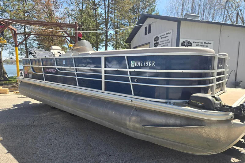Slide: The Image of 2013 Starcraft Stardeck 236 Cruise-N-Fish pontoon boat docked near a marina. - 1