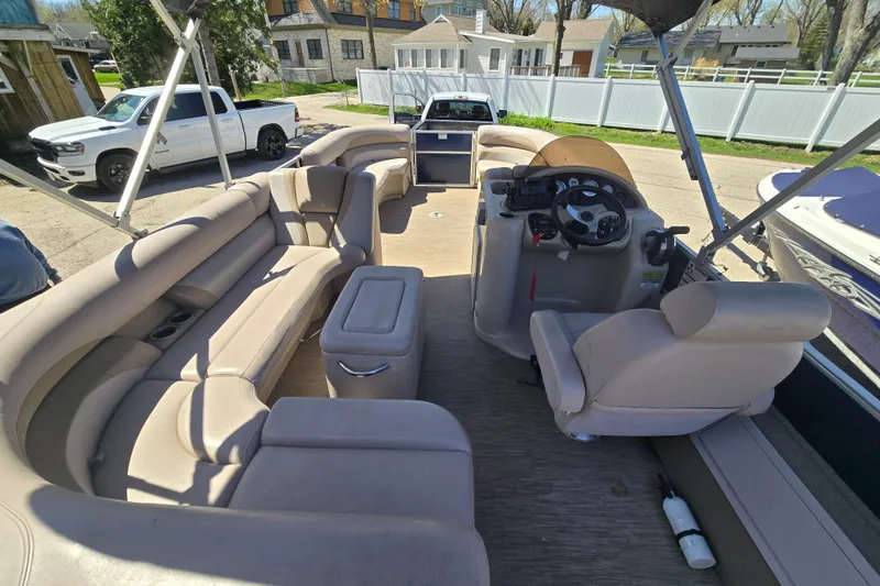 Slide: The Image of 2013 Starcraft Stardeck 236 Cruise-N-Fish boat interior with beige seating and steering console. - 14