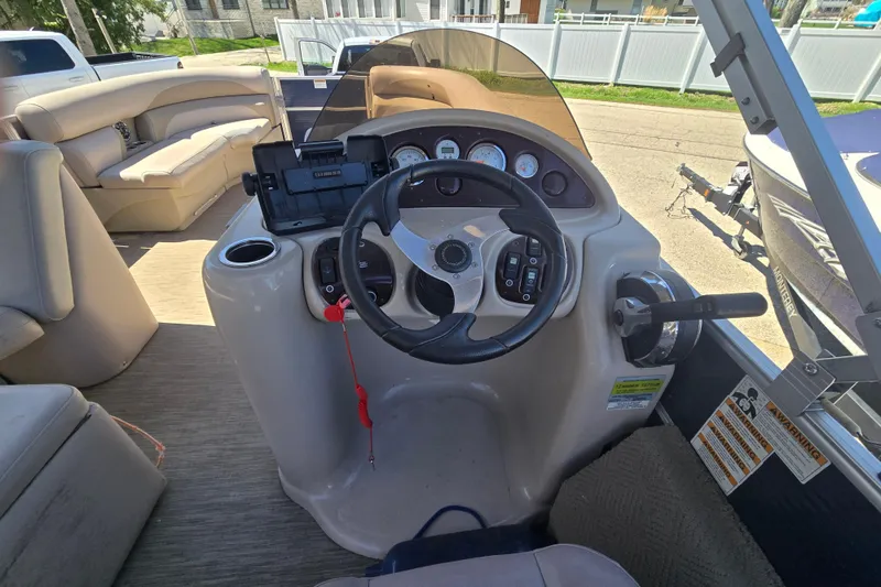Slide: The Image of 2013 Starcraft Stardeck 236 Cruise-N-Fish boat dashboard with steering wheel and controls. - 15