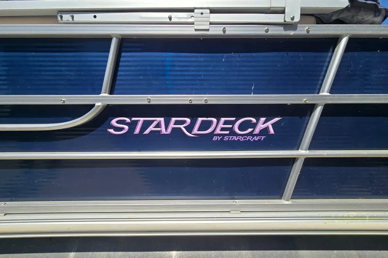 Slide: The Image of 2013 Starcraft Stardeck 236 Cruise-N-Fish boat logo on blue panel. - 2