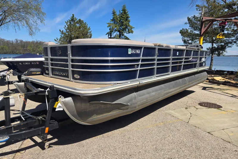 Slide: The Image of 2013 Starcraft Stardeck 236 Cruise-N-Fish pontoon boat on trailer by a lake. - 4