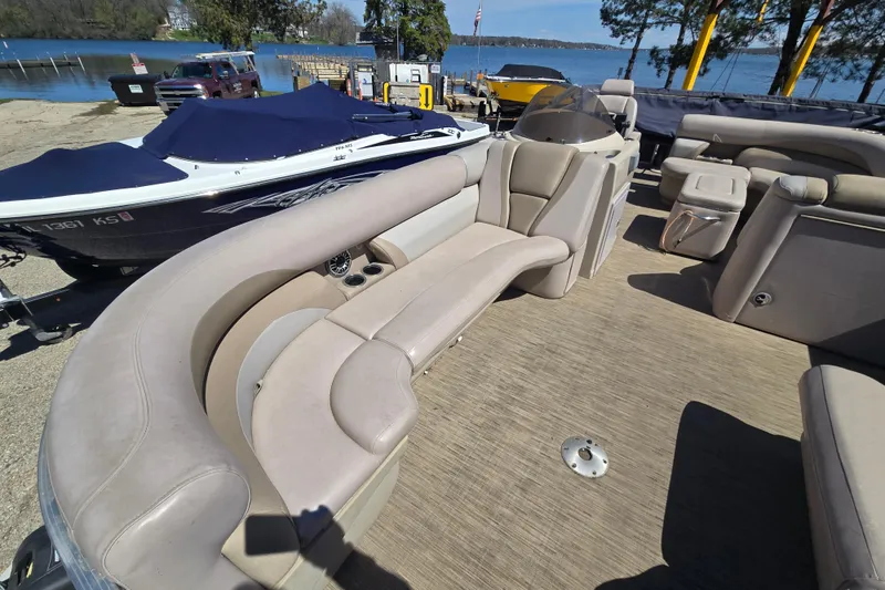 Slide: The Image of 2013 Starcraft Stardeck 236 Cruise-N-Fish pontoon boat with beige seating, docked by a lake. - 7