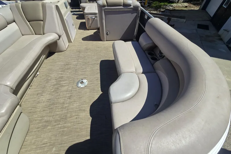 Slide: The Image of 2013 Starcraft Stardeck 236 Cruise-N-Fish boat interior with beige seating and cup holders. - 8