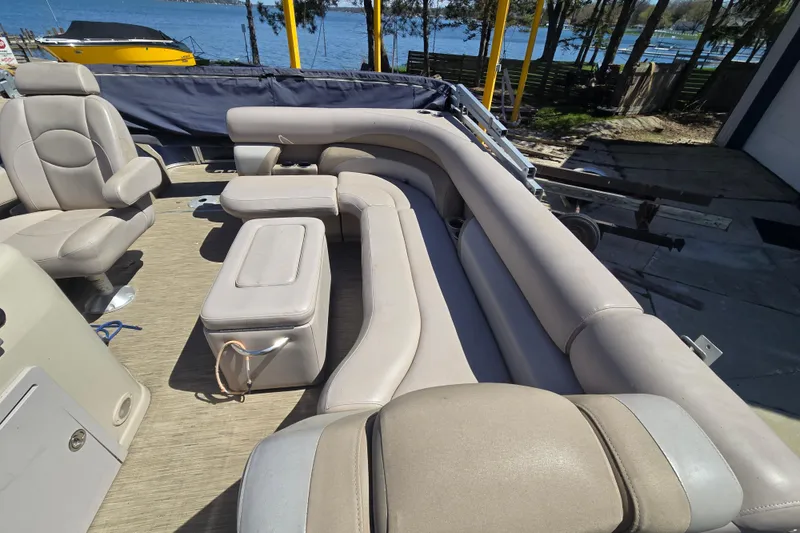 Slide: The Image of 2013 Starcraft Stardeck 236 Cruise-N-Fish boat interior with beige seating and lake view. - 9