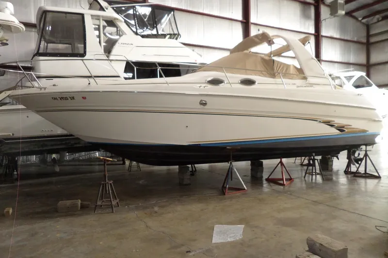 The Image of 1997 Sea Ray 290 Sundancer boat in indoor storage on stands. - 0