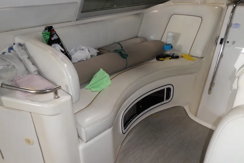 Slide: The Image of Interior seating area of a 1997 Sea Ray 290 Sundancer boat with various items. - 13