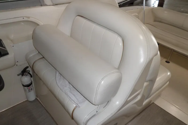 Slide: The Image of 1997 Sea Ray 290 Sundancer interior with white leather seating and fire extinguisher. - 14