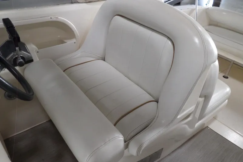 Slide: The Image of White leather seating in 1997 Sea Ray 290 Sundancer boat cockpit. - 15