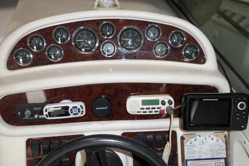 Slide: The Image of 1997 Sea Ray 290 Sundancer dashboard with gauges, controls, and navigation equipment. - 16