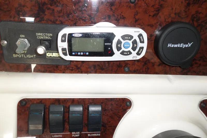 Slide: The Image of Control panel of a 1997 Sea Ray 290 Sundancer boat with spotlight and audio controls. - 17