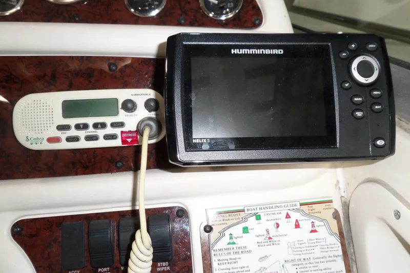 Slide: The Image of Control panel of a 1997 Sea Ray 290 Sundancer with Humminbird and Cobra devices. - 18