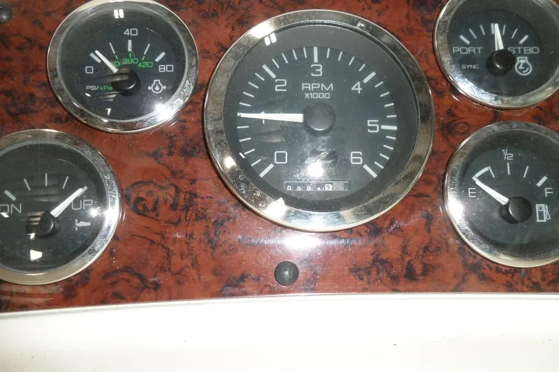 Slide: The Image of 1997 Sea Ray 290 Sundancer dashboard with RPM and fuel gauges. - 19