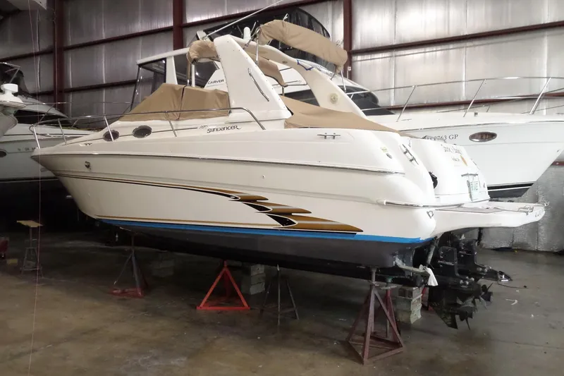 Slide: The Image of 1997 Sea Ray 290 Sundancer boat in storage, elevated on stands. - 2
