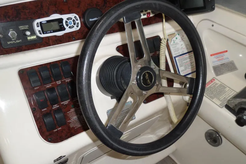 Slide: The Image of Steering wheel and control panel of 1997 Sea Ray 290 Sundancer boat. - 21