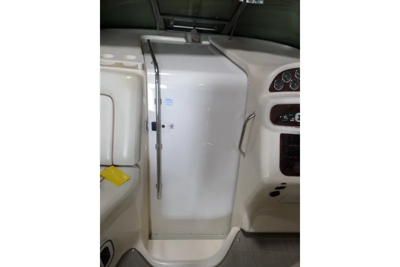 Slide: The Image of 1997 Sea Ray 290 Sundancer cabin entrance with control panel and seating area. - 23