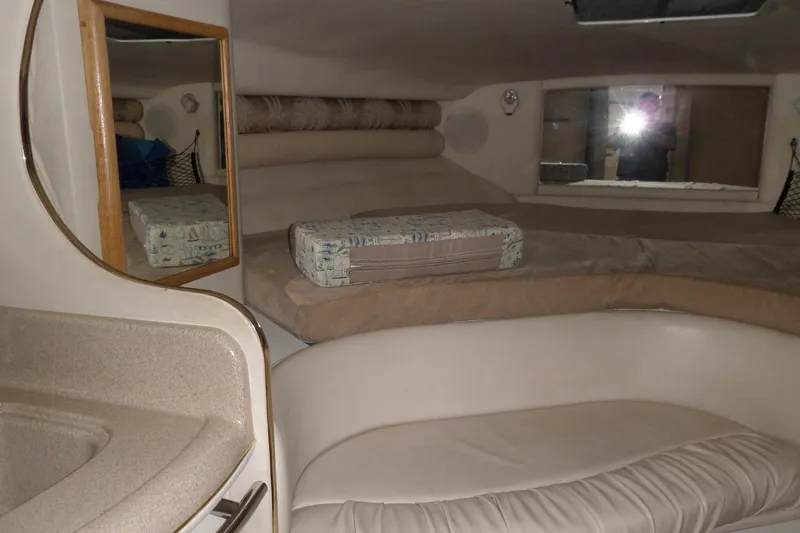 Slide: The Image of Interior cabin of 1997 Sea Ray 290 Sundancer with seating and mirror. - 24