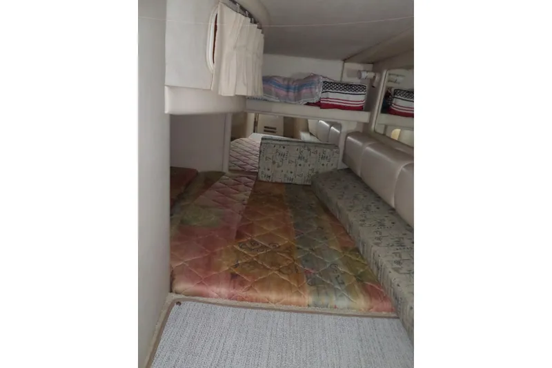 Slide: The Image of Interior cabin of 1997 Sea Ray 290 Sundancer with colorful bedding and seating. - 34