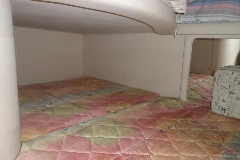 Slide: The Image of Interior cabin of 1997 Sea Ray 290 Sundancer with colorful bedding. - 35