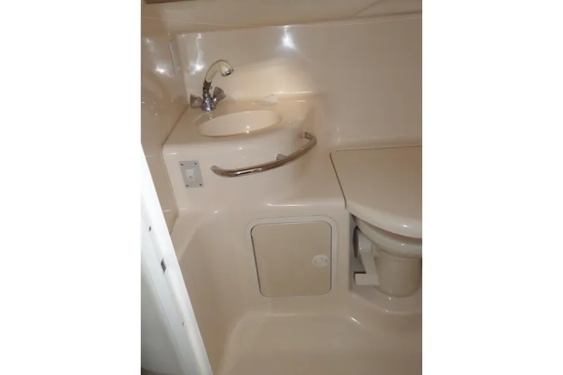 Slide: The Image of Bathroom area of 1997 Sea Ray 290 Sundancer boat with sink and toilet. - 41