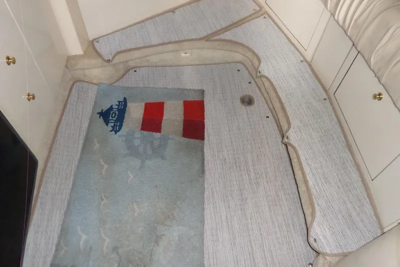 Slide: The Image of Interior carpet of 1997 Sea Ray 290 Sundancer boat, featuring nautical design elements. - 43