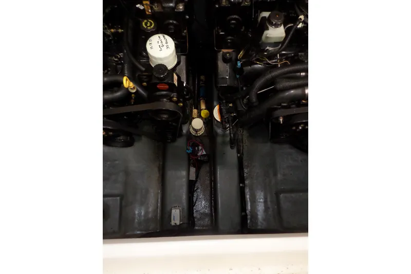 Slide: The Image of Engine compartment of a 1997 Sea Ray 290 Sundancer boat, showcasing mechanical components. - 48
