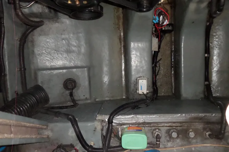 Slide: The Image of 1997 Sea Ray 290 Sundancer engine compartment with wiring and components visible. - 49
