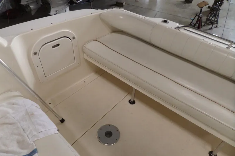 Slide: The Image of Interior seating of a 1997 Sea Ray 290 Sundancer boat, featuring white upholstery. - 5