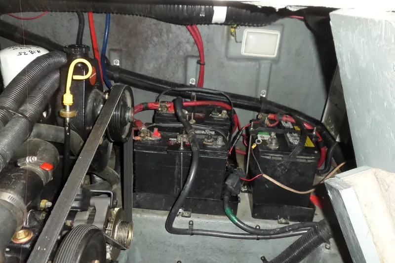 Slide: The Image of Engine compartment of a 1997 Sea Ray 290 Sundancer with visible batteries and wiring. - 51