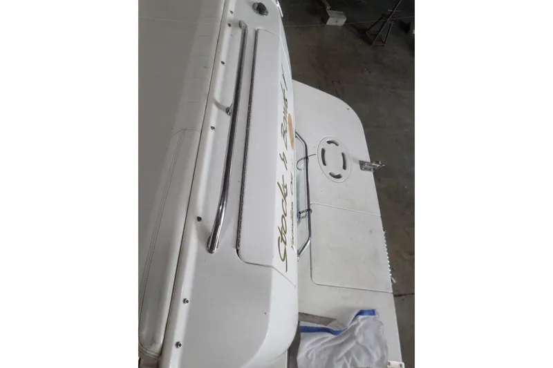 Slide: The Image of 1997 Sea Ray 290 Sundancer boat deck with chrome railing and swim platform. - 52