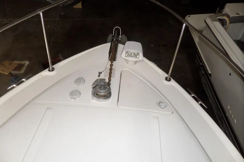 Slide: The Image of 1997 Sea Ray 290 Sundancer boat deck with anchor chain and railing. - 53