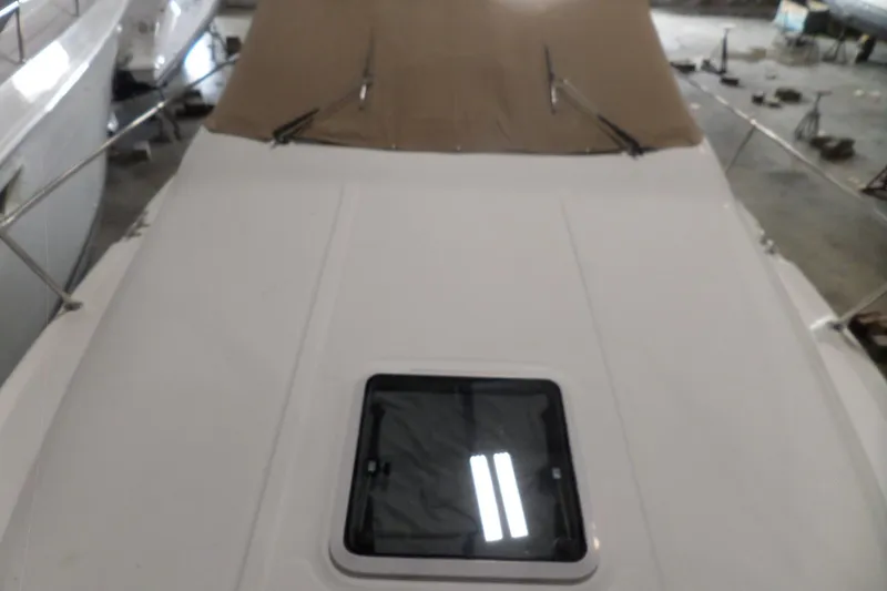 Slide: The Image of 1997 Sea Ray 290 Sundancer boat deck with tan canopy in storage. - 54