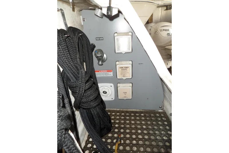 Slide: The Image of 1997 Sea Ray 290 Sundancer utility panel with ropes and power connections. - 57