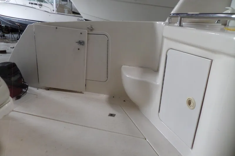 Slide: The Image of 1997 Sea Ray 290 Sundancer boat interior with storage compartments and seating area. - 7