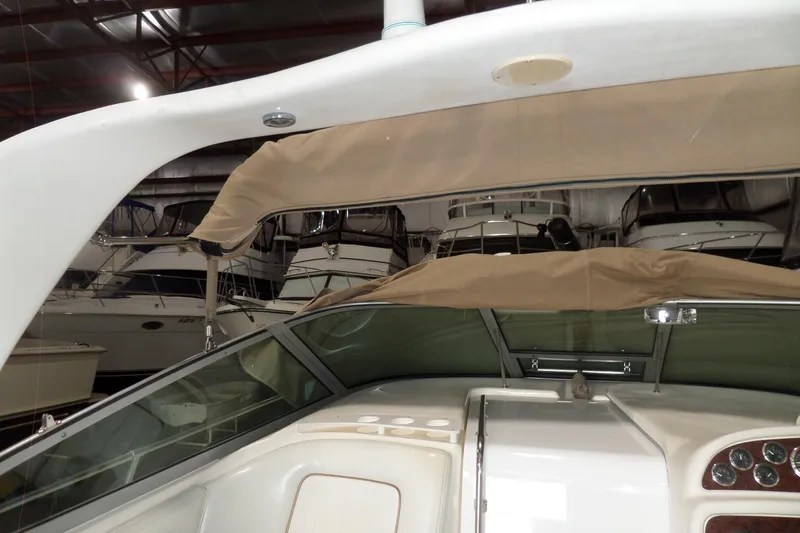 Slide: The Image of 1997 Sea Ray 290 Sundancer interior view in a boat storage facility. - 9