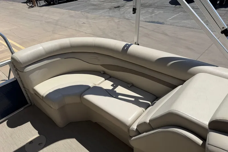 Slide: The Image of 2017 Bennington SX 22 Quad Bench boat interior with beige seating and sunlit deck. - 13