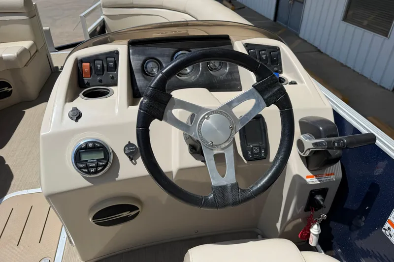 Slide: The Image of Steering console of 2017 Bennington SX 22 Quad Bench pontoon boat with controls and gauges. - 15