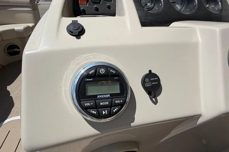Slide: The Image of 2017 Bennington SX 22 Quad Bench dashboard with Kicker audio system and USB input. - 17