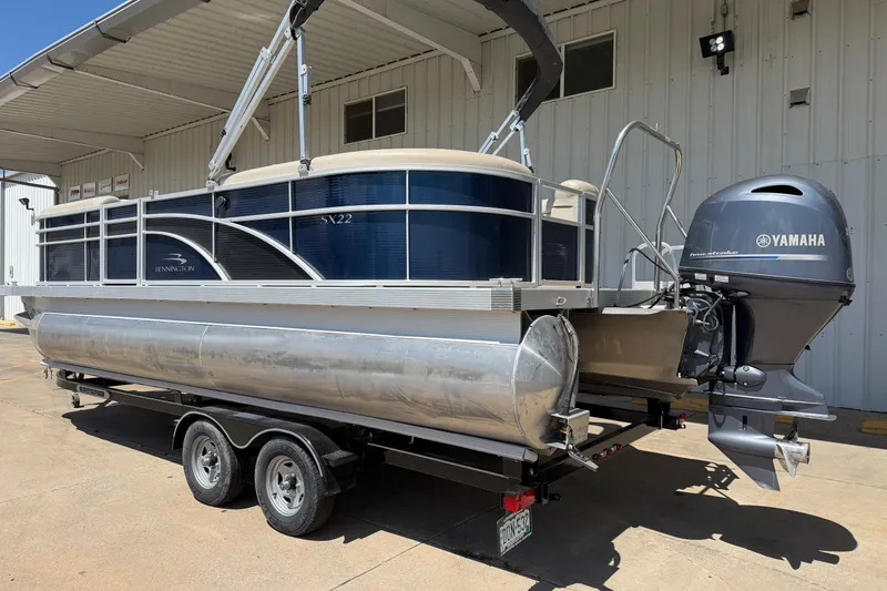 Slide: The Image of 2017 Bennington SX 22 Quad Bench pontoon boat with Yamaha motor on trailer. - 3