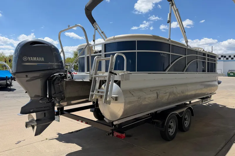 Slide: The Image of 2017 Bennington SX 22 Quad Bench pontoon boat with Yamaha motor on trailer. - 5