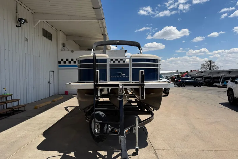 Slide: The Image of 2017 Bennington SX 22 Quad Bench pontoon boat on trailer, parked outdoors. - 8