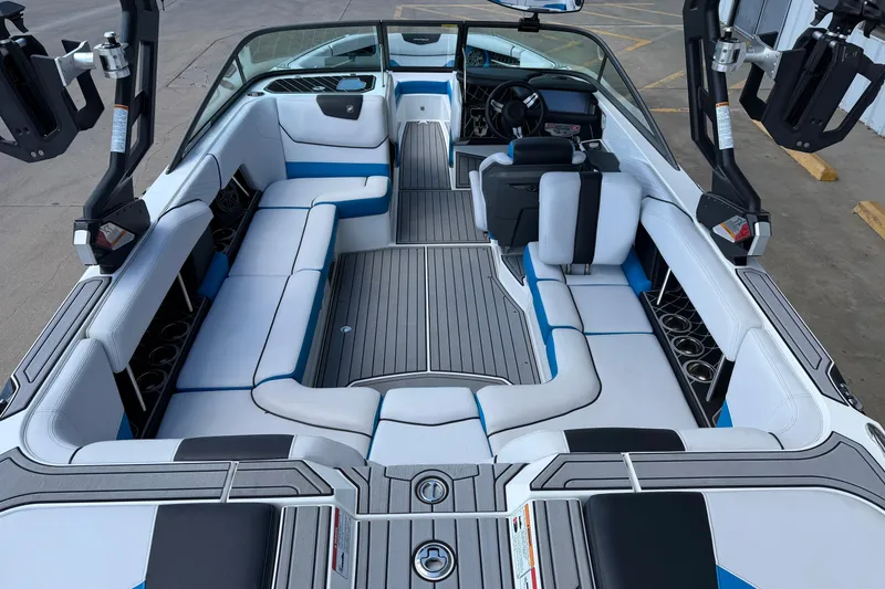 Slide: The Image of 2019 Nautique Super Air Nautique GS22 interior with white and blue seating, sleek design. - 10
